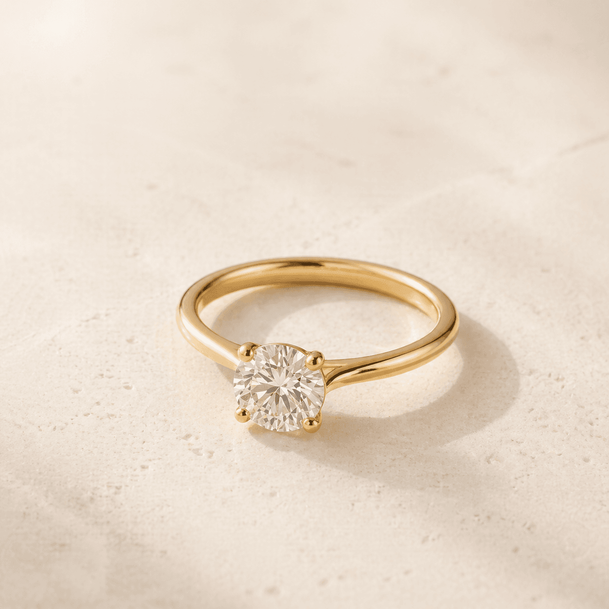 Solitaire moissanite ring on warm ivory background