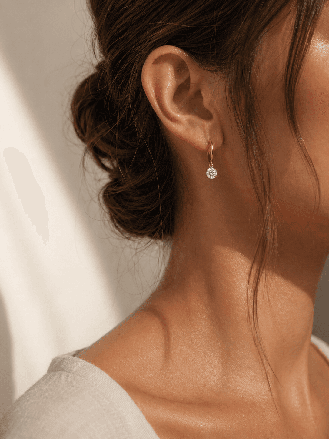 Moissanite earring worn in warm natural light