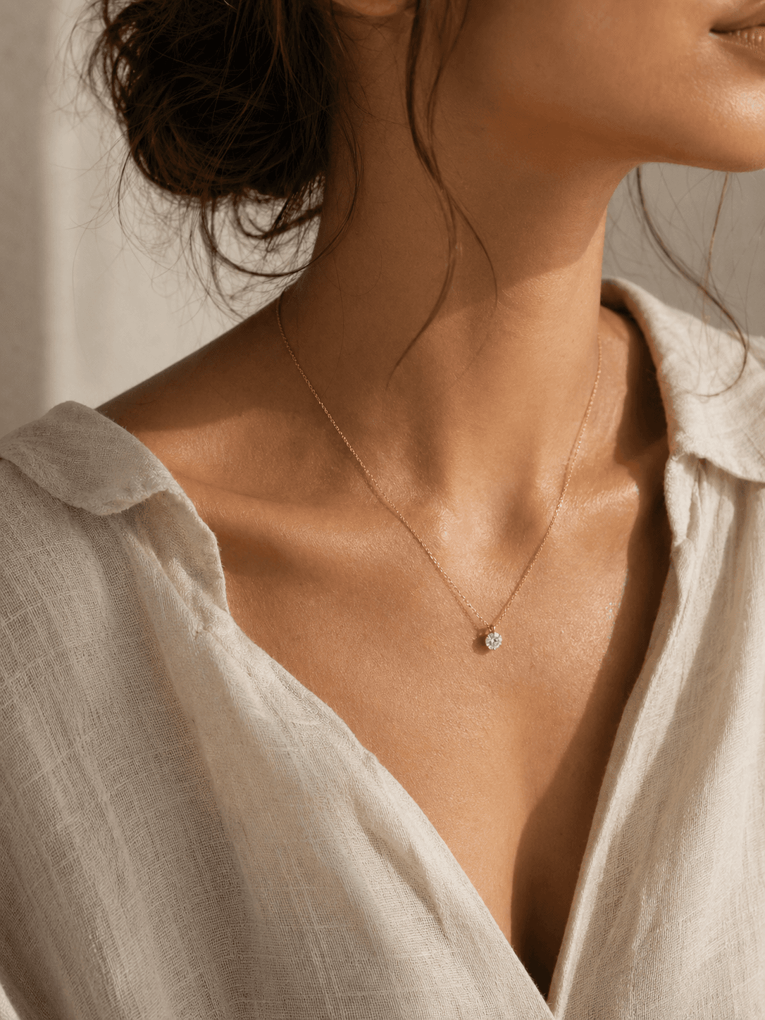 Moissanite pendant necklace worn with ivory linen